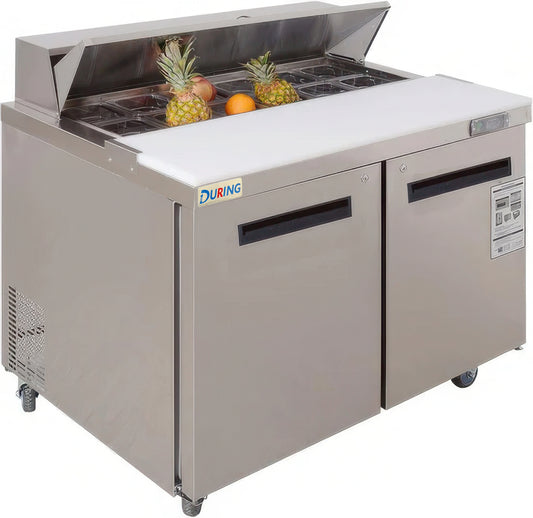 Commercial refrigerator with open lid showing pineapples and oranges on a white background